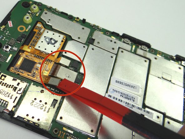 Use the flat end of the black spudger to disconnect the three display assembly ribbon connectors (revealed by removing the metal shield).