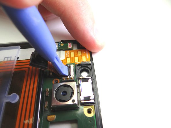 Picture 3: Use the blue pry tool to lift the black swing bar to open the ZIF connector.