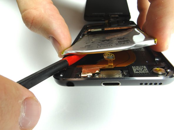 Picture 2: Use the spudger to pry up the upper right corner of the battery.