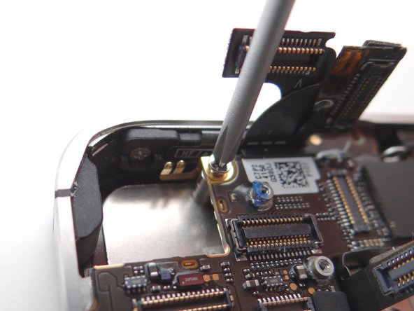 Picture 2: Also from SLOT 8, replace 2.6 mm Phillips screw that secures Gold Grounding Clip to logic board near rear camera opening.