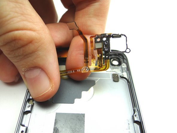 Peel the power &amp; volume button cable free from the rear case.