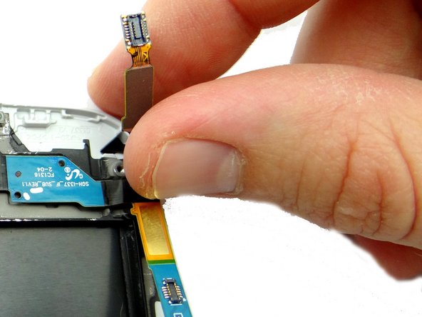 Picture 3: The soft keys ribbon is adhered to the charging port ribbon - use your fingers to peel them apart.