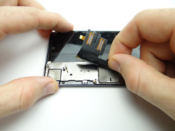 Picture 2: Flip display cable over and adhere it to raised plate in center of sliding bracket.