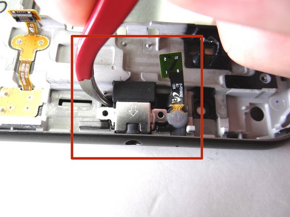 The headphone jack and microphone are connected as one assembly, held in place with mild adhesive: