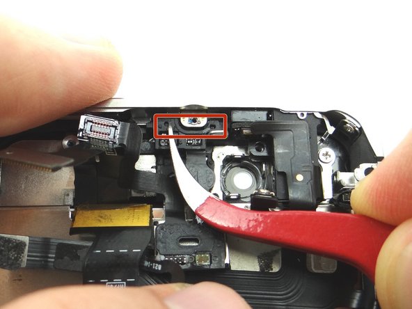 Picture 2: Use the Curved Tip Tweezers to push the Sensor Cable onto Sensor area. Notice the two small holes that align with the tabs on the area.