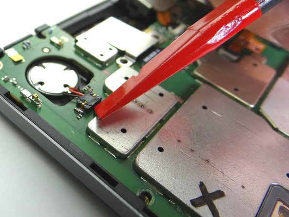 Pictures 1 &amp; 2: Use the corner of the spudger to pry up the speaker connector.