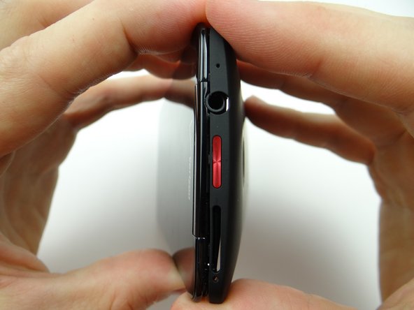 Pictures 1 &amp; 2: Work the battery cover towards the top.