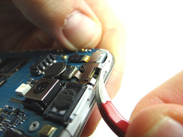 Use curved-tip tweezers to grab metal shield and work it around the tabs creating tension (marked in Picture 2).