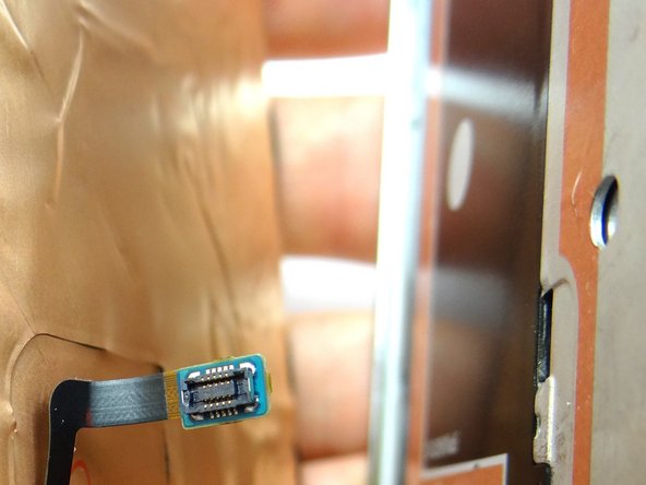 Pictures 2 &amp; 3: Push home button cable through mid-frame so it moves freely with the screen.