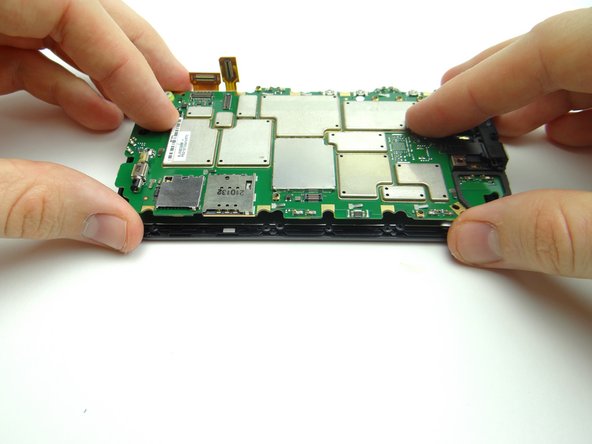 Picture 3: Use your fingers to pick up the side of the logic board with the SIM and SD card trays.