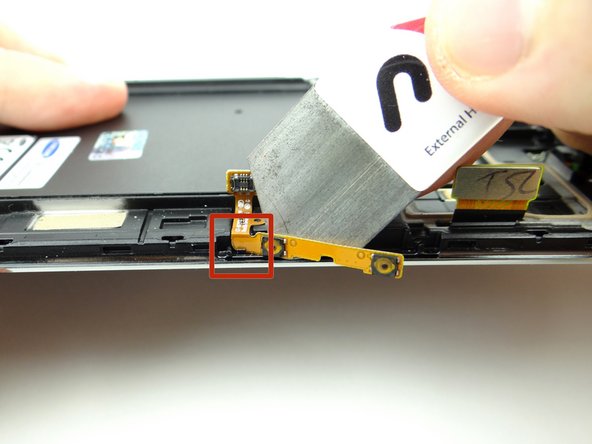 Pictures 1 &amp; 2: Use the iSesamo to wedge behind the volume rocker cable.  Peel the cable away from the front panel until you reach the joint in the red square.