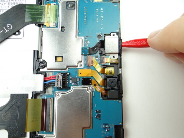 Pictures 1 &amp; 2: Use the pointed tip of the spudger to lift the headset jack out of its socket.