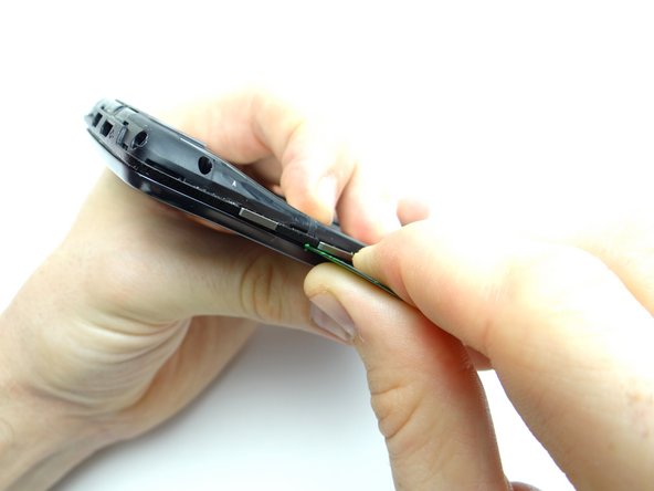 Pictures 2 &amp; 3: Separate the mid-frame under the volume rocker with a guitar pick.