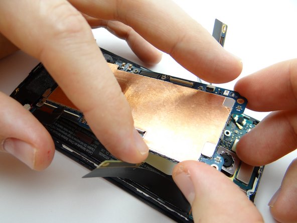 Brush cables out of the way as you continue seating the logic board.