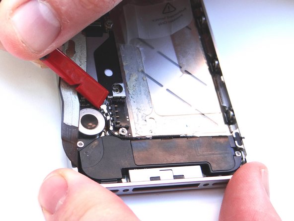 Picture 1: Place Black Spudger under antenna. Gently lift to release antenna from its socket on the logic board.