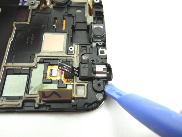 Use the Blue Pry Tool to lift the headphone jack from its position.