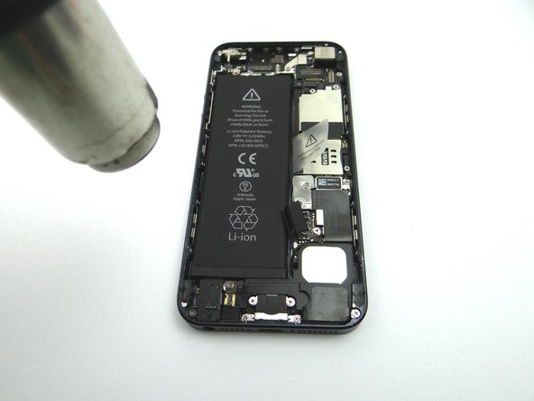 Apply low-level heat (100* Celcius or less) to edges of battery for 60 seconds to loosen the adhesive securing the battery to the iPhone.