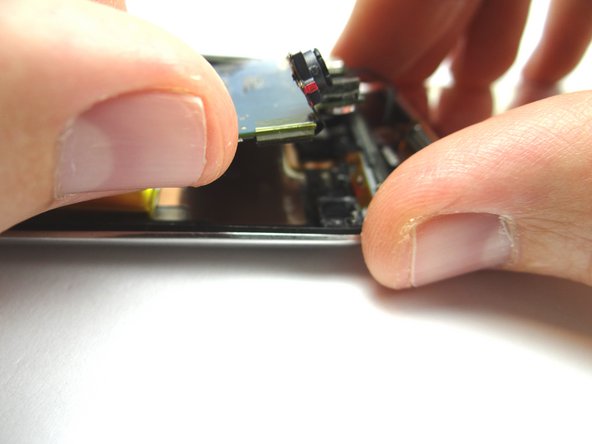 Picture 3: Use your fingers to lift the top right of the logic board one inch above the rear case.