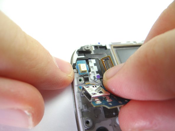 Guide microphone in first then continue seating the charging port.