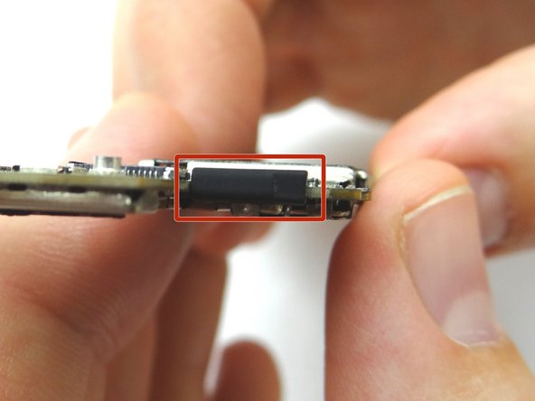 Once you have a good grip on the logic board, use your right hand to brush away cables near the top while pulling the logic board towards you until it is free from the mid-frame. Place in ZONE III.