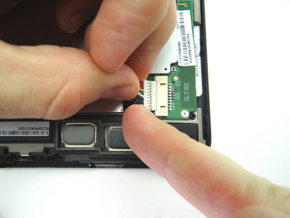 Picture 2: Use your finger to put mild tension at the top of the connector while using the spudger to push back the bottom of the connector.