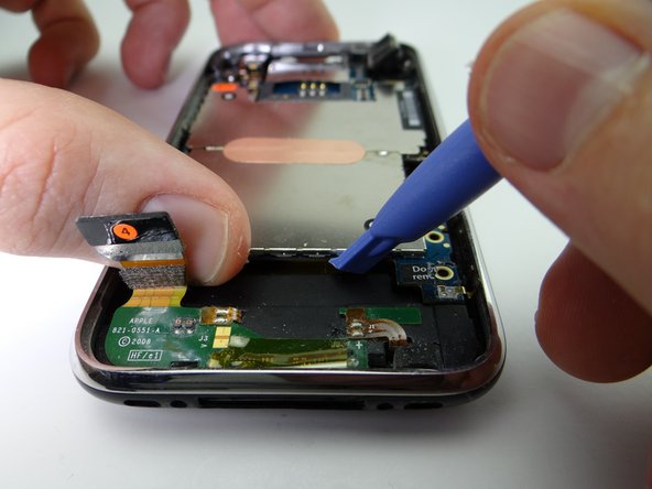 Picture 1: Use blue pry tool to lift the logic board up from the rear case just enough to grab it with your fingers.