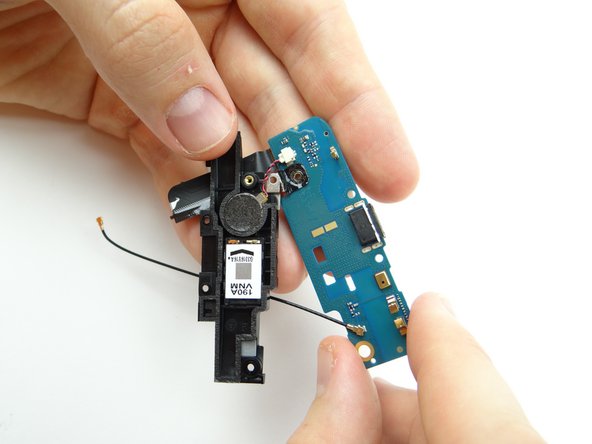 Pictures 2 &amp; 3: Fold vibrator bracket onto charging port.