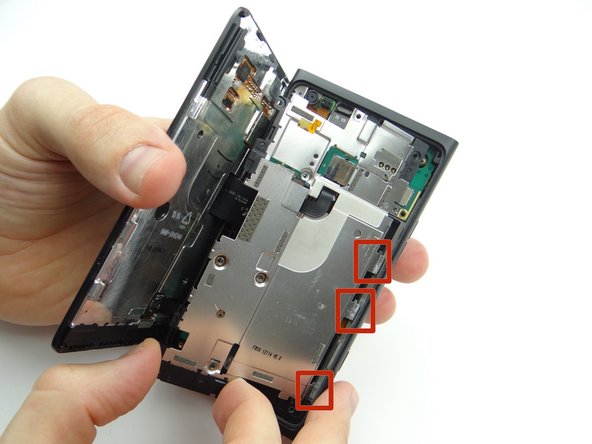 Picture 2: Lift from the top and bottom taking care not to torque the battery connector (red square in Picture 2).
