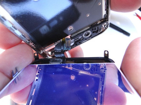 Continue pulling the display assembly away from the mid-frame until separated.  Keep the broken display assembly on the scrap paper and set it off to the side (you may need to harvest parts from it).