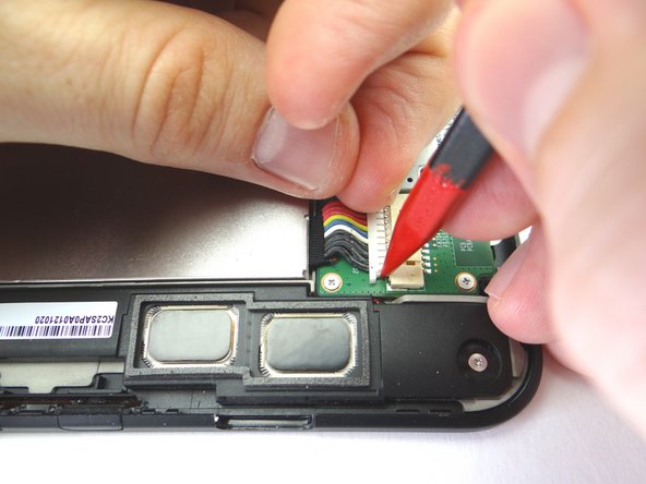 Picture 1: Use the pointed end of the spudger to push back the top of the battery connector slightly.