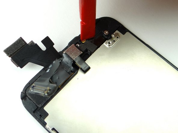 Use the flat edge of the spudger to press earpiece speaker contacts (right side of the cable) firmly into place.