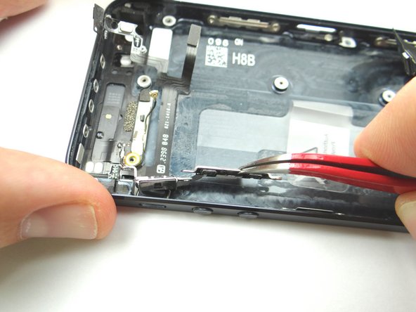 Picture 2: Use Curved Tip Tweezers to separate the ribbon cable from the rear case near the volume buttons and mute switch.