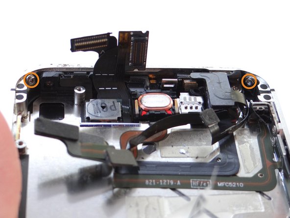 There may be a piece of black electrical tape covering the screw in the upper left-hand corner of the phone.  If it's there, remove and discard it.