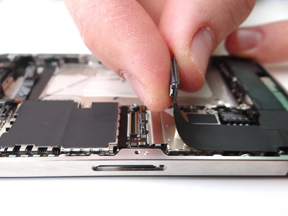 Fold the charging port assembly cable back into position and reconnect it to its socket on the logic board.