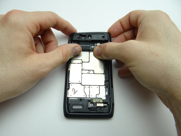 Seat the HDMI and charging ports first, then continue snapping rear frame into place.