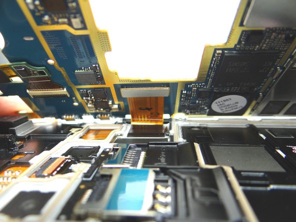 Bring logic board and front panel together at a 45° angle.  Push display cable firmly into place.