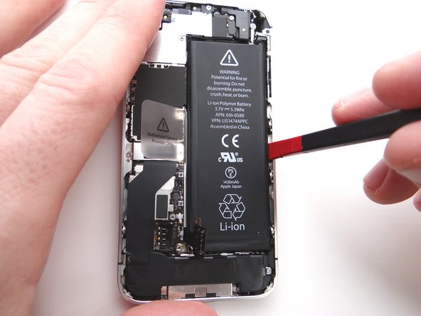 Wedge the flat end of the Black Spudger on the right edge of the battery.  Gently pry up in three or four spots along the right edge to release the adhesive adhering it to the mid-frame.