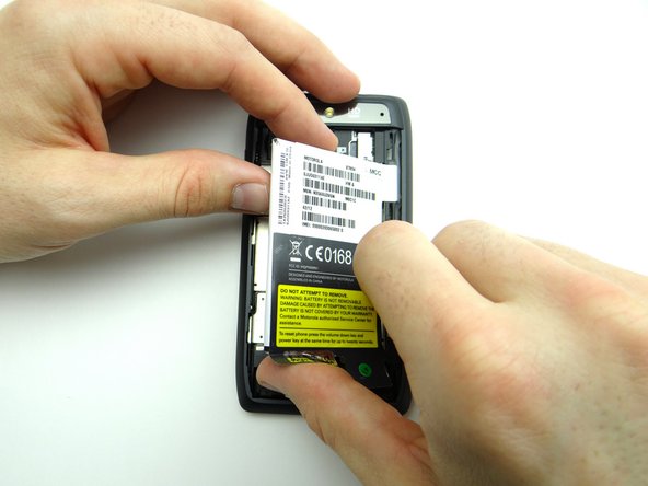 Grab the upper-left corner with your fingers.  Wedge your thumb on the opposite hand under the bottom-left corner.