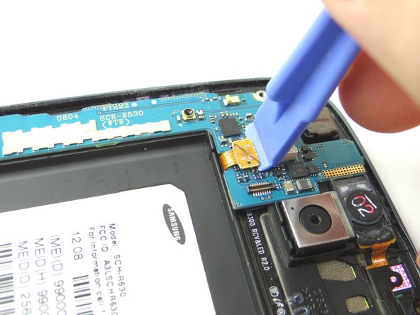 Picture 2: Use the Blue Pry Tool to release the earpiece speaker/volume button cable connector.