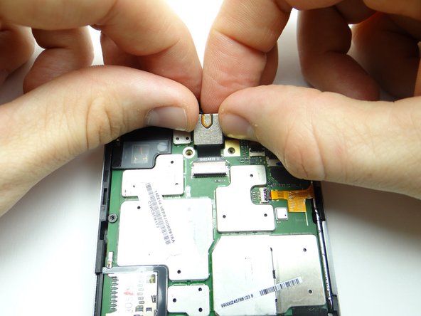 Lift the rear camera out of its socket while guiding the camera cable out of the ZIF connector.  Place camera in COMPARTMENT D.