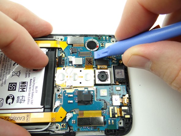 Pictures 1 &amp; 2: Use the blue pry tool to gently lift the top half of the daughter board up from the mid-frame.