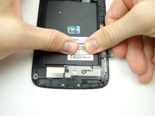 Quickly place the IMEI sticker on the replacement display and smooth it out.