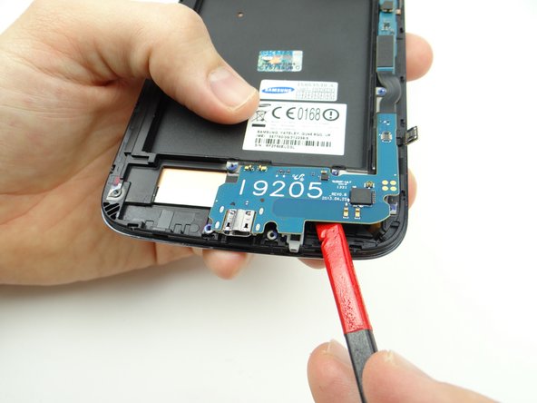 Picture 1: Wedge flat end of spudger exactly where shown and lift slightly.