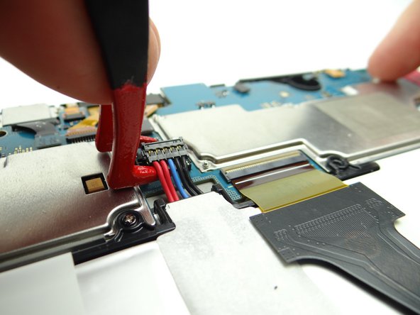 Lift battery connector straight up from the left side to dislodge it.