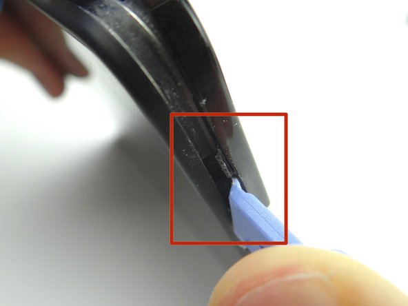 Picture 3: Using your fingers, gently pry up the corner of the rear trim.