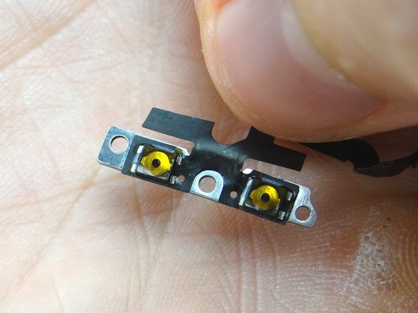 Picture 1: Gently remove the metal bracket from the volume button ribbon cable.