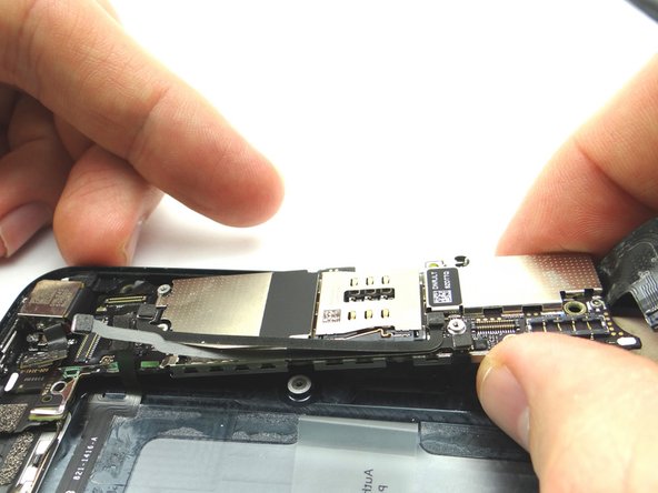 Picture 3: Push the logic board down into its position on the mid-frame.