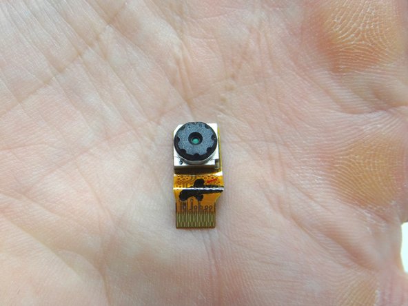 Picture 3: Pull the cable free with your fingers and remove the front-facing camera. Place it in COMPARTMENT D.