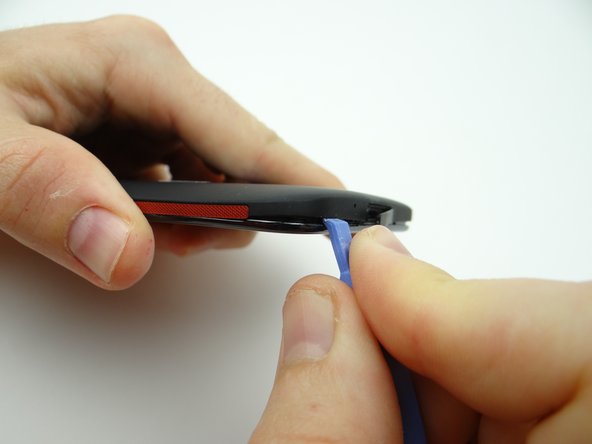 Insert the spudger in the lower-left corner.  Work your way around the corner, then up to the volume rocker.