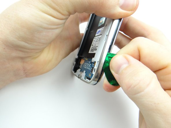 Picture 3: Reinsert the guitar pick below the volume rocker and work your way down.